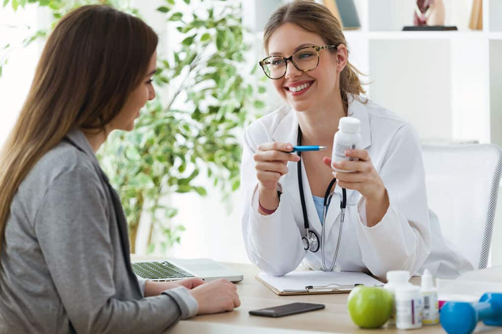 functional nutritionist talking to woman about taking magnesium supplements