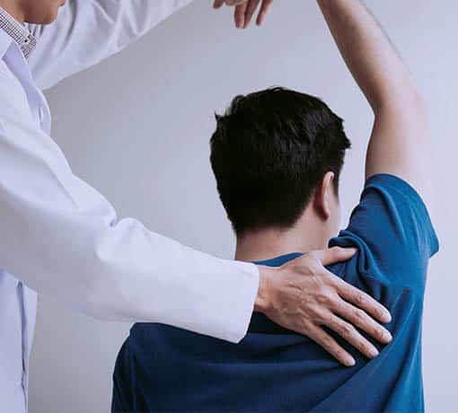 Man being assessed by chiropractor for mobility and function