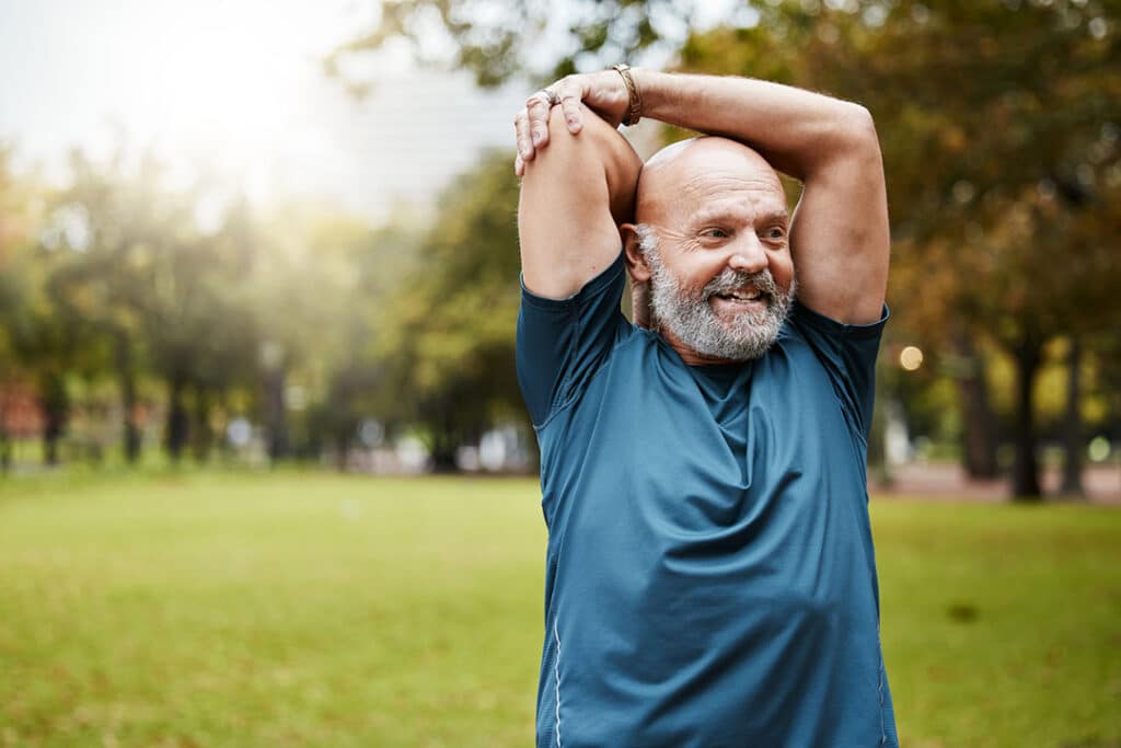 Senior man stretching outdoors before exercising