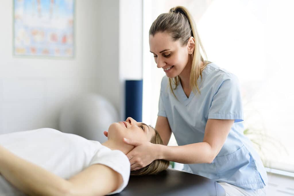 Chiropractor checking a woman cervical spine function - spinal nerves - spine to symptoms - AlignLife