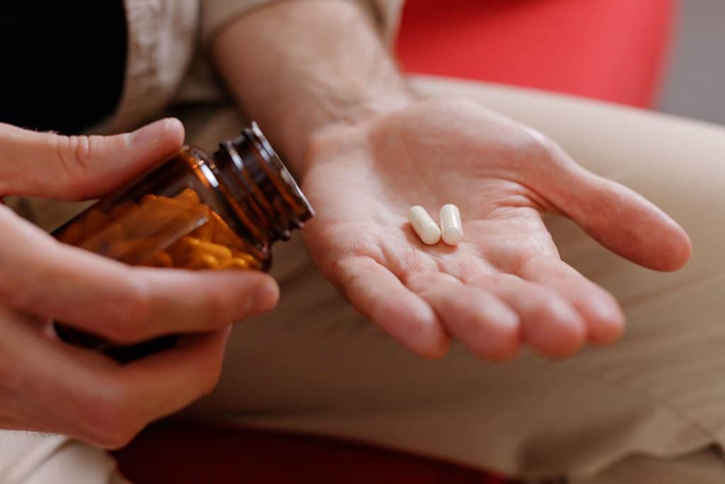 man taking supplements - probiotic and prebiotic