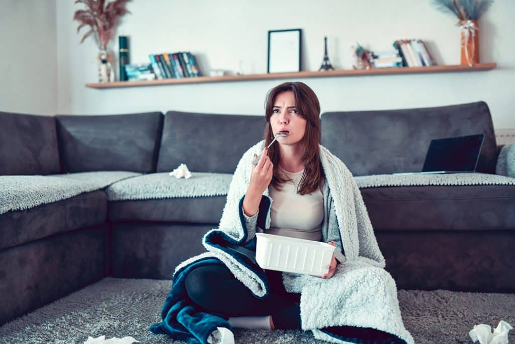 Depressed Female Eating Ice Cream At Home - Causes of Stress Belly