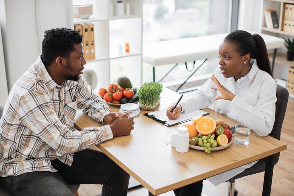 Man working with functional nutritionists on which is the best greens supplement