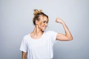 Woman flexing muscle - muscle health