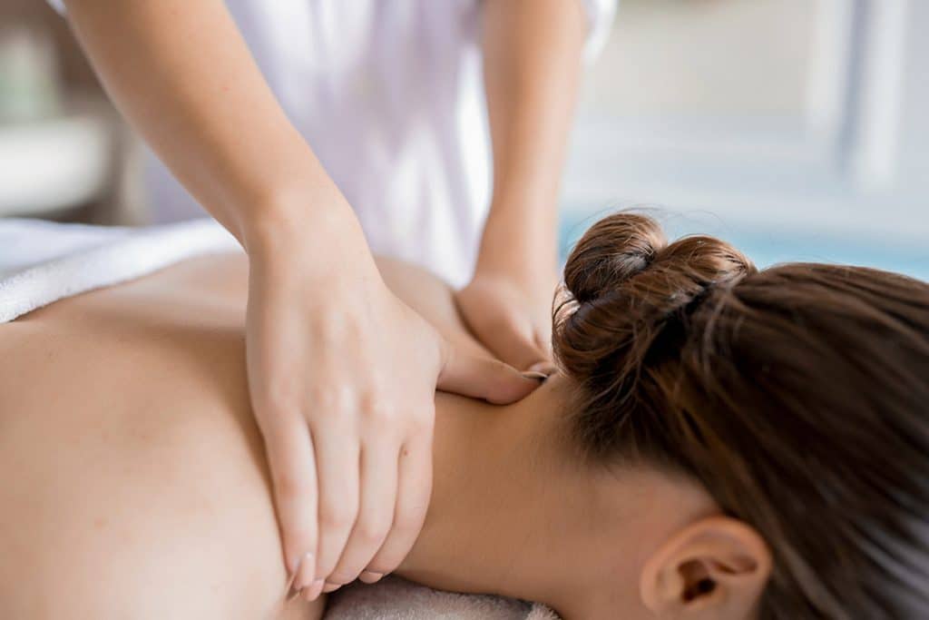 Massage therapy on a woman's neck