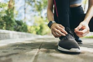 Close up of woman's foot in running shoe - benefits of custom orthotics