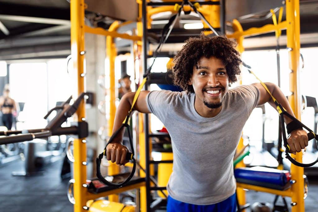 Man training in gym - preventive care - benefits of corporate wellness