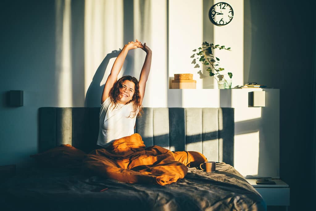 Woman waking up rested after a good night's sleep