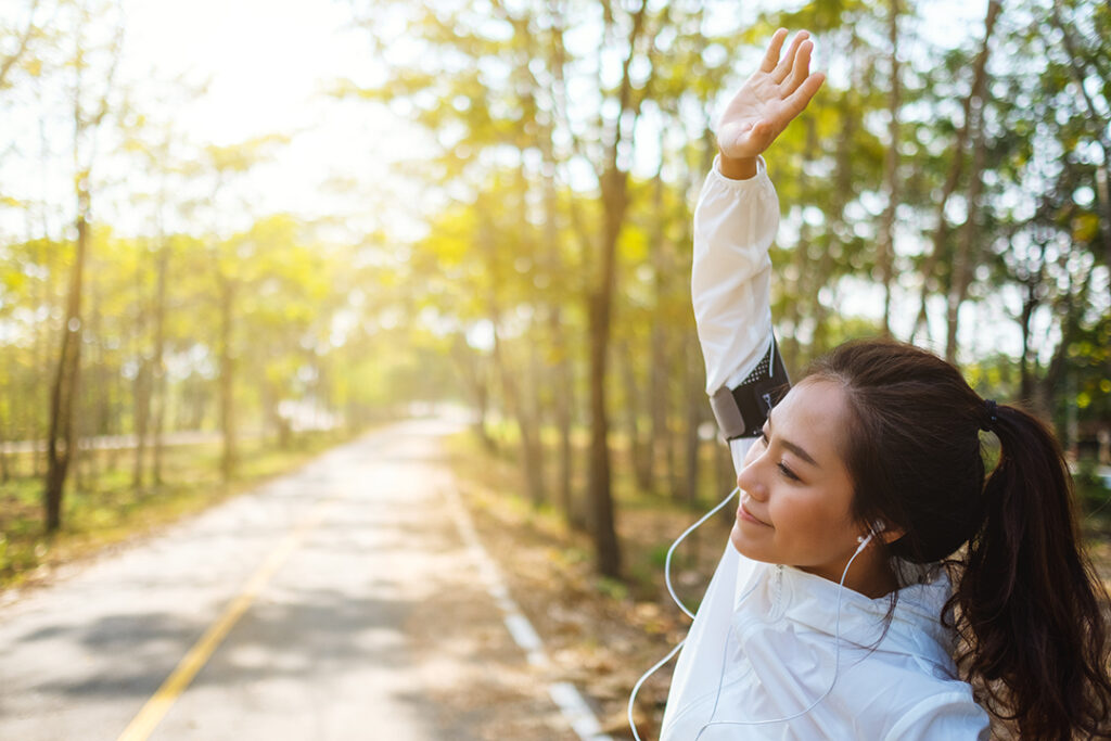 Young woman stretching before going for a morning run - immune boosting habits