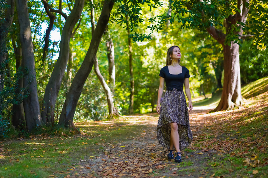 Woman enjoying a walk in nature. Benefits of Reduced Screen Time in adults