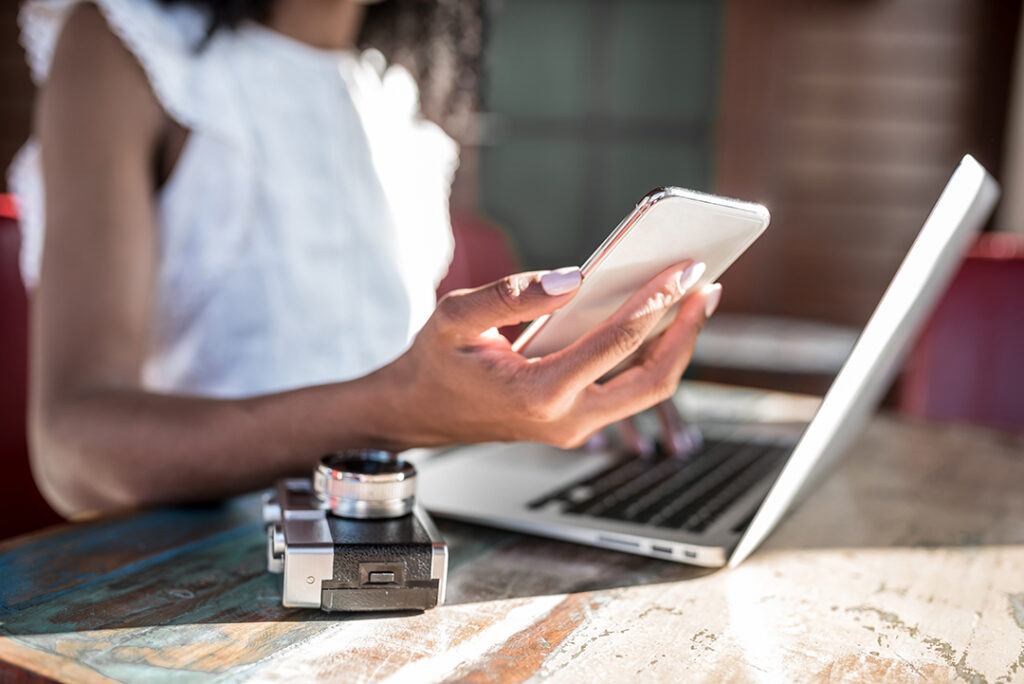 Businesswoman working from home on her computer and speaking on the mobile phone