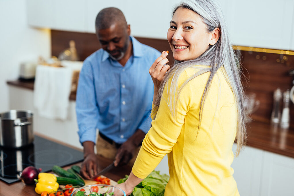 Couple prepping health ingredients in kitchen together - immune boosting