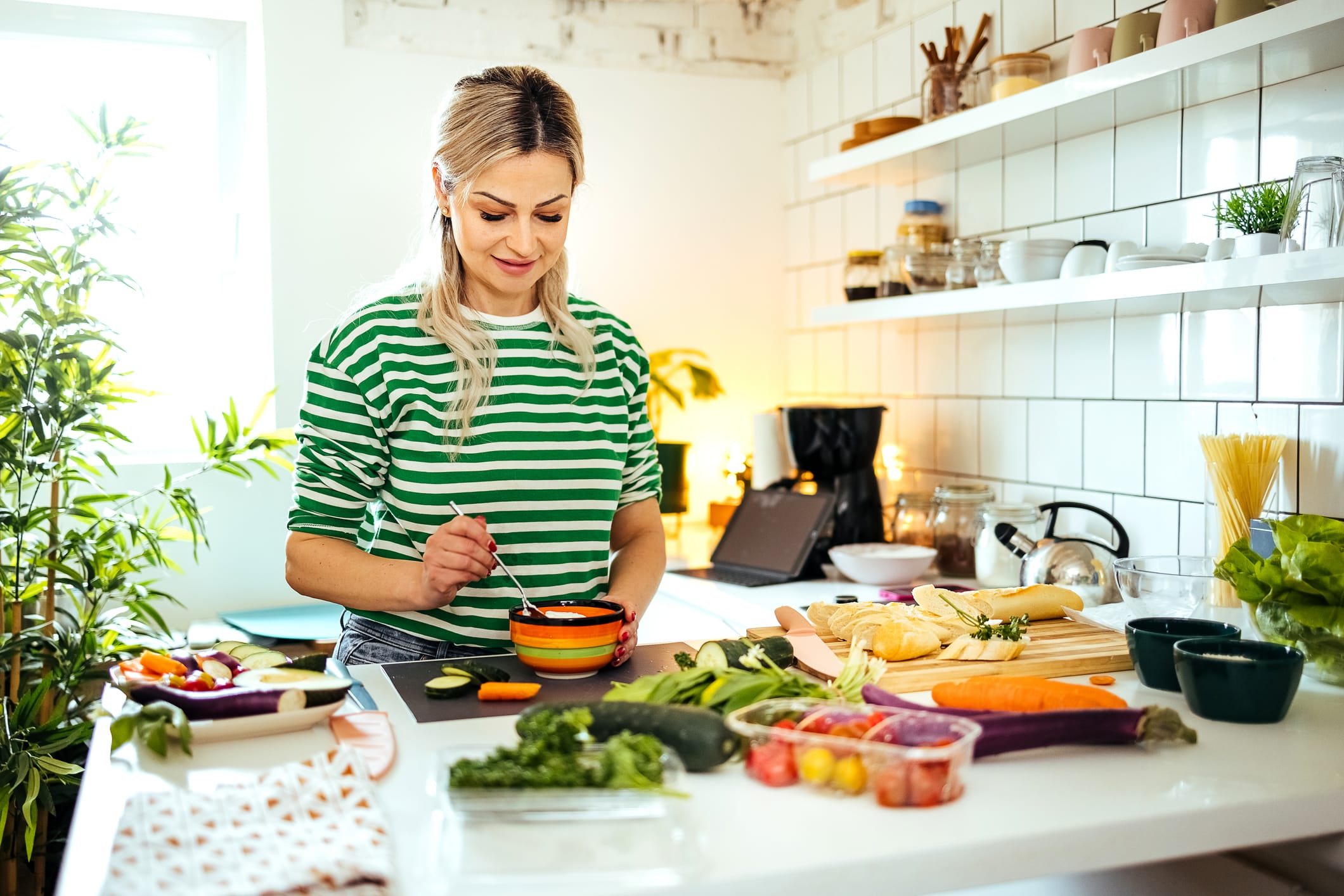 Woman preparing a healthy meal for a balanced diet in her kitchen