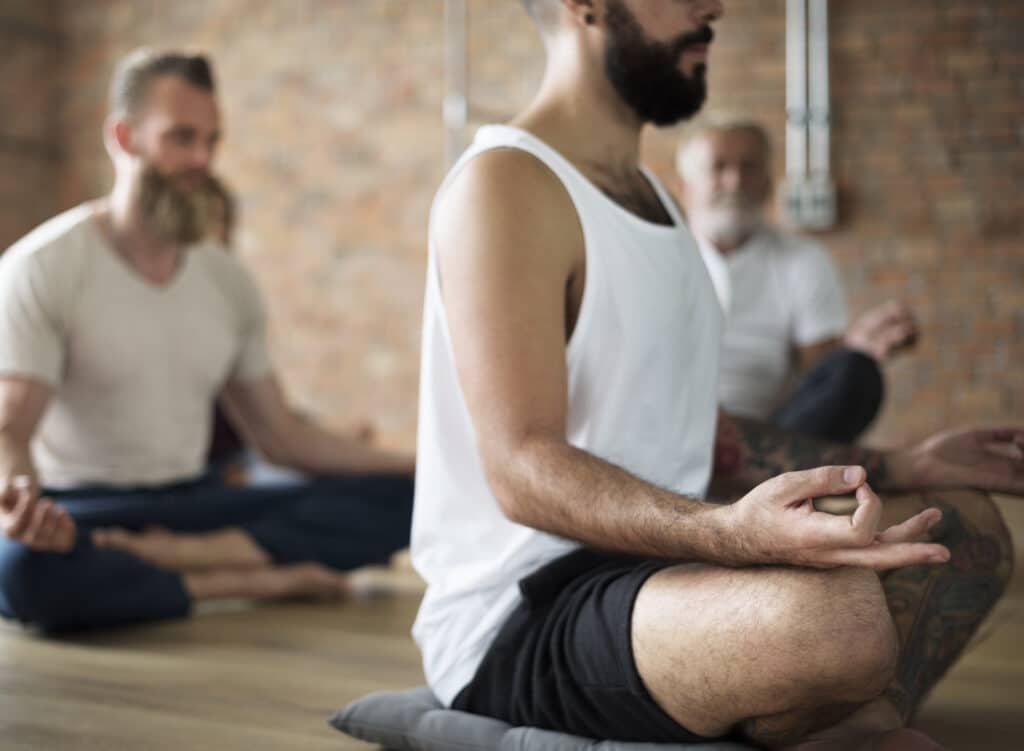 Man meditating in exercise class