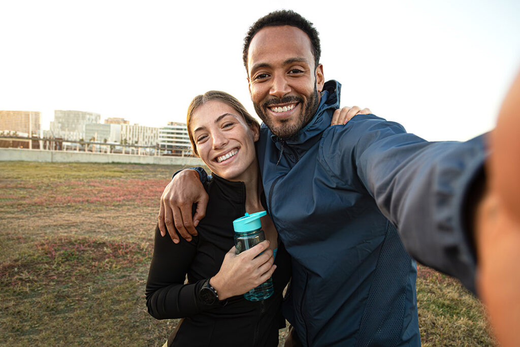 Happy couple outside working out - managing stress and weight