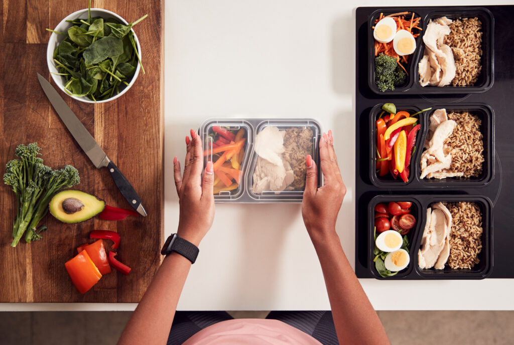 Woman preparing a batch of healthy meals for a balanced diet