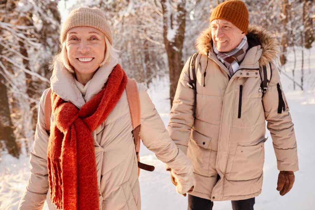 Mature couple taking a winter hike - natural ways to relieve stress