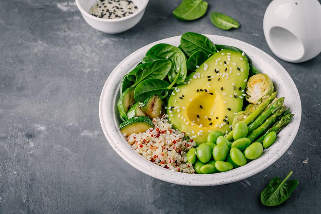 Bowl of leafy greens, avocado and quinoa - heart healthy foods