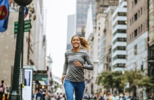 Fatigue Fighters A young Caucasian woman jogging on New York City streets