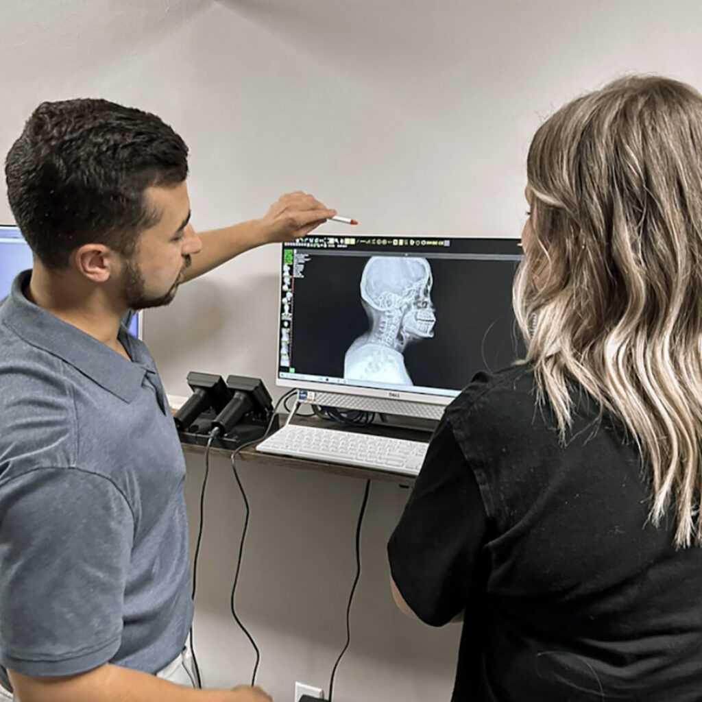 AlignLife Chiropractor reviewing neck x-ray with patient