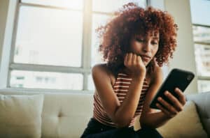 Woman on phone researching - Safety of Chiropractic