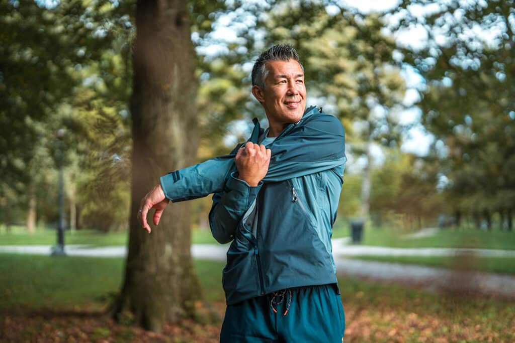 Healthy active Man stretching low back before running