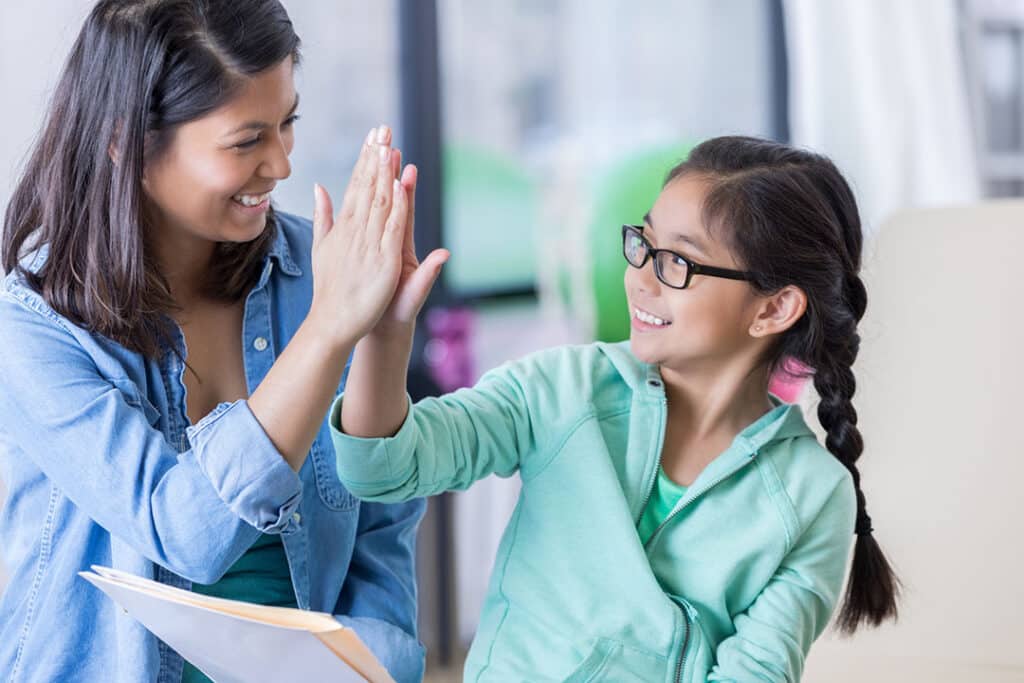 Chiropractor gives young girl a high five