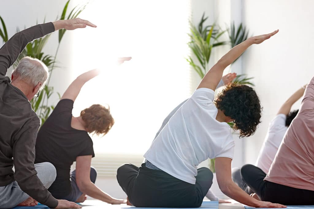 Group of people doing yoga showing mobility of low back