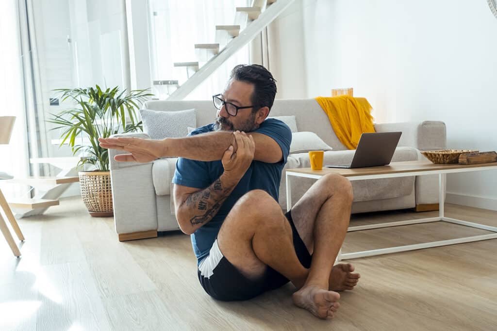 Man doing stretches to prevent repetitive strain injury RSI